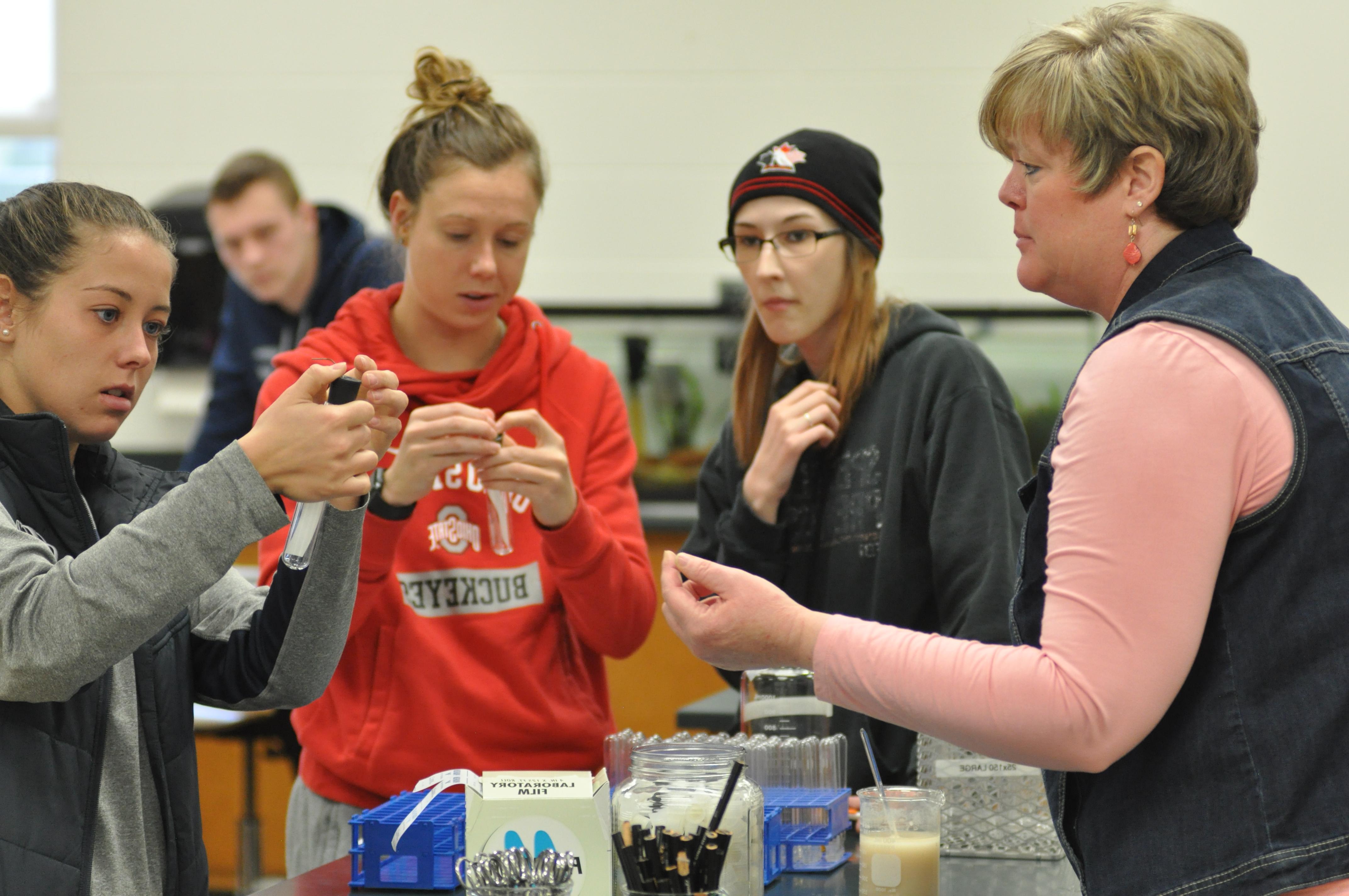 Faculty and students working on a lab.